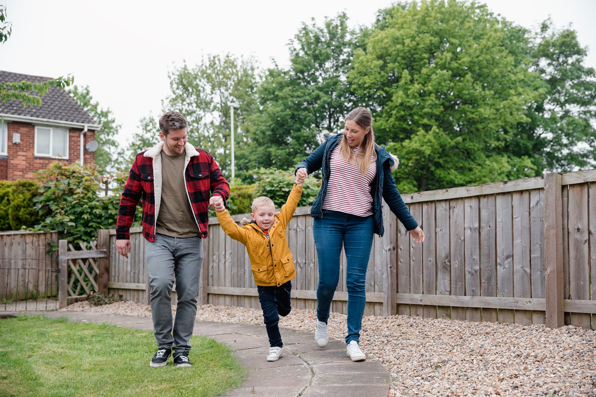 Family walking together in a suburban garden