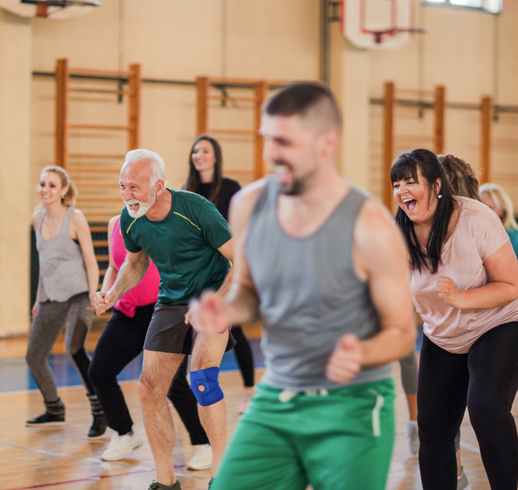 Local people exercise class in a school gymnasium